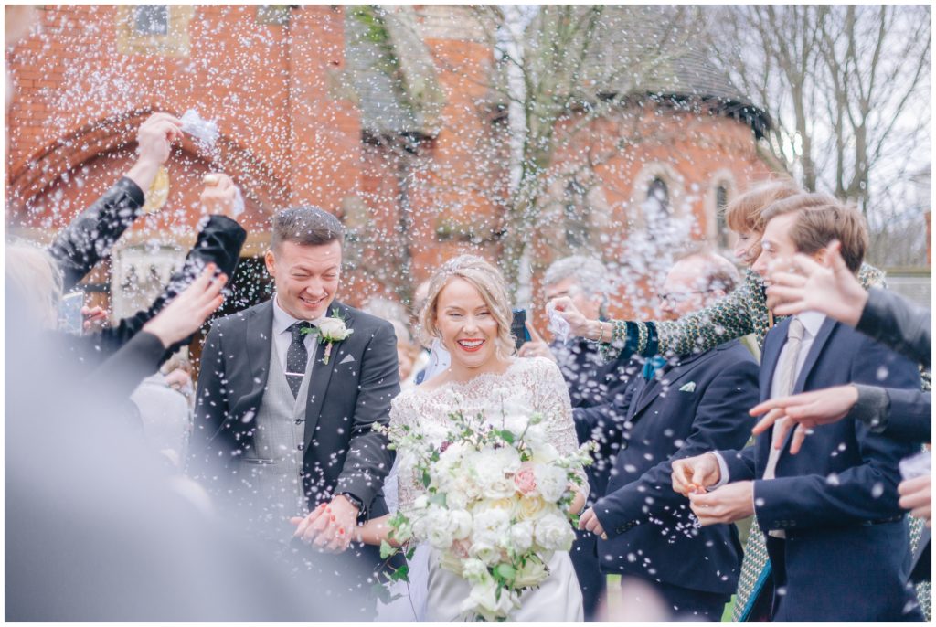 Religious wedding ceremony Ormskirk, bride and groom exiting church with Bio-degradable confetti