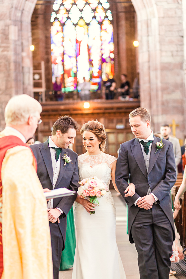 Bride-groom-meet-at-alter-first-look-st-oswalds-church-malpas