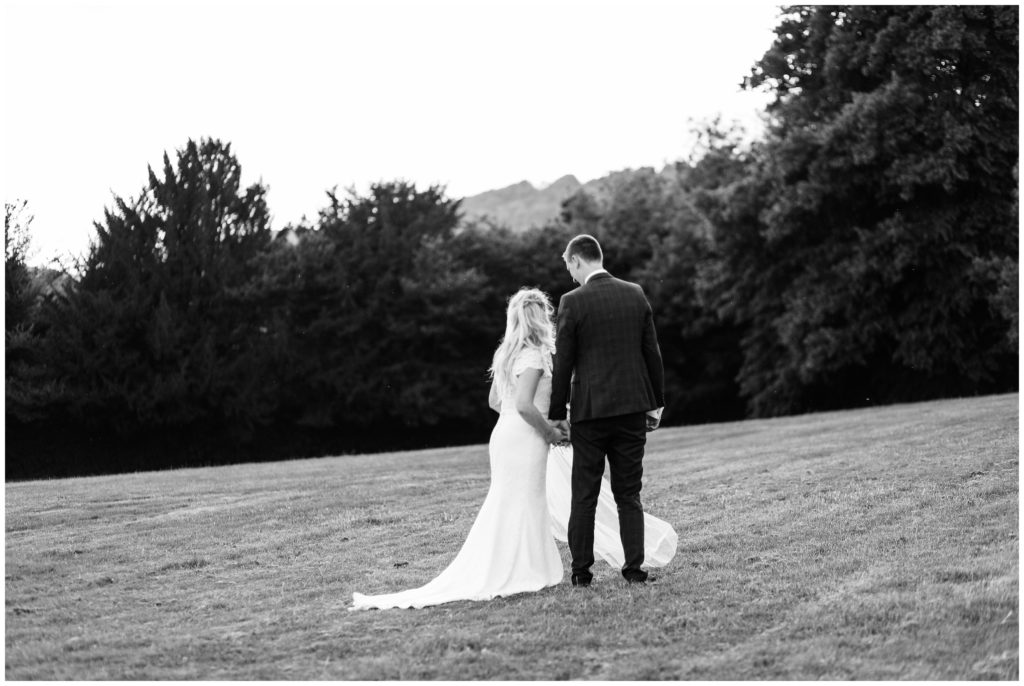Black and white classic portrait of bride and groom at sunset in Luxury Surrey manor